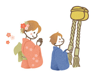 神社でお参りをする男の子と女の子