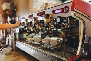 Barista preparing espresso at a busy coffee shop during morning hours