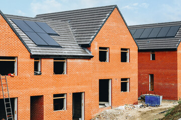 New residential construction with modern solar panels in a developing neighborhood