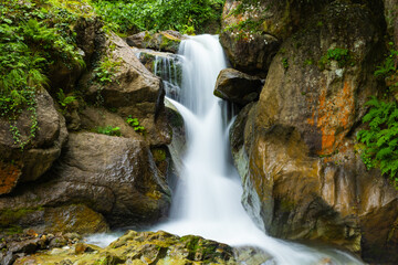 Long exposure shot of the little waterfall in the forest.