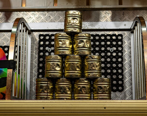 10 empty Cans are stacked for knockdown game at a beer funfair festival. traditional carnival munich oktoberfest game.