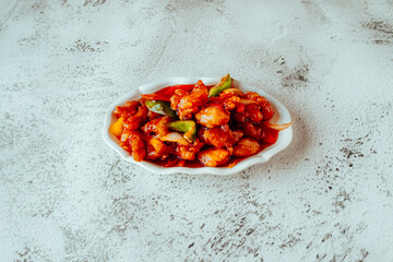 Sweet and Sour Chicken with Peppers and Onions on White Plate