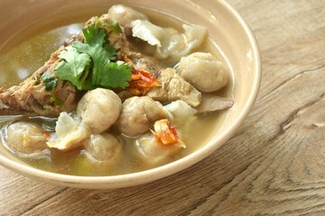 hot and spicy pork bone with fish dumpling soup on bowl  