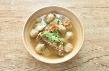 hot and spicy pork bone with fish dumpling soup on bowl  