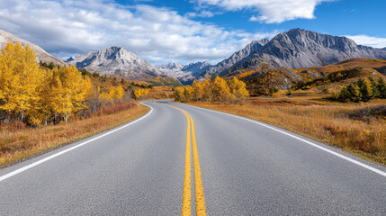 Naklejka premium Scenic view of winding road through autumn foliage and mountains