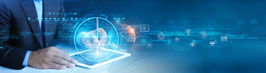 Software as a Service. Businessman holding and using a digital tablet device with cloud-based applications, real-time data synchronization, and seamless user experience concept.