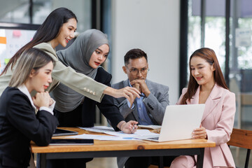 Happy asian business woman executive ceo leader discussing project management planning strategy working with diverse colleagues company team at office corporate board group meeting.
