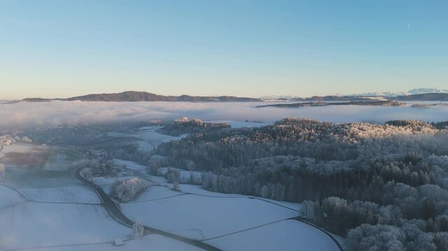 Aerial view over a snowy winter landscape in the early evening