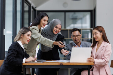 Happy asian business woman executive ceo leader discussing project management planning strategy working with diverse colleagues company team at office corporate board group meeting.
