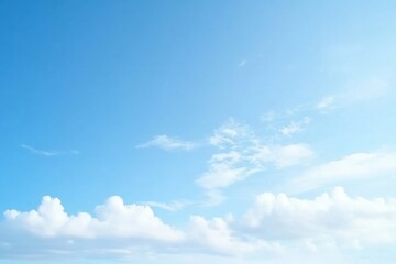 Obraz premium A tranquil sky filled with soft, fluffy clouds under a bright blue atmosphere, ideal for peaceful backgrounds.