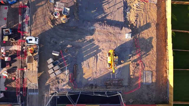 Aerial view from drone at Construction project showing site preparation with machinery and materials moving