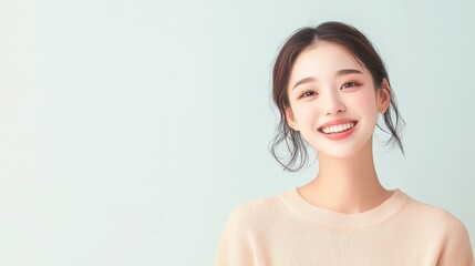 Woman with a smile on her face is wearing a white shirt. She is looking at the camera