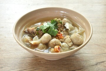 hot and spicy pork bone with fish dumpling soup on bowl  