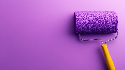 Obraz premium Purple paint roller with a yellow handle is on a purple background. Concept of creativity and artistic expression, as the bright colors of the roller and the background contrast with each other