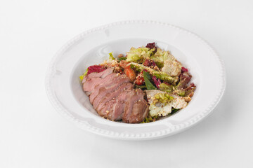 Fine cuisine on a white plate isolated on a white background. Author's cuisine