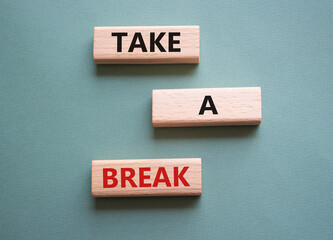 Take a break symbol. Concept words Take a break on wooden blocks. Beautiful grey green background. Business and Take a break concept. Copy space.