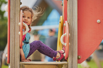 Charming child playing on a playground in Ringkobing Denmark