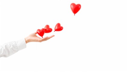 Close-up of a female hand releasing red heart-shaped balloons on a white background. Concept of love, emotions, giving, and romance.