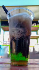 Es teler, a traditional Indonesian dessert, consists of ice, avocado, young coconut, jackfruit, etc. Served with coconut milk and sweetened condensed milk.