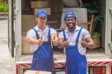 Happy service team of delivery worker working load customer boxes from truck and makes inventory of packed boxes and writes data to clipboard with smile confident and professional service