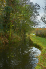 Digital oil painting of autumn, fall tree and leaf colours along the Caldon canal at Denford in Staffordshire.