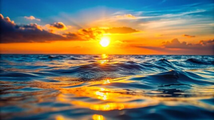 Obraz premium Stunning Sunset over Calm Blue Ocean Water with Bokeh Effect - Stock Photo