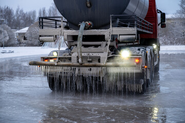 water truck sprays water in winter and makes a skating rink in the yard