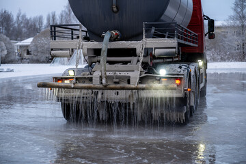 water truck sprays water in winter and makes a skating rink in the yard	