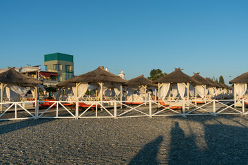 Rows of bungalows on a sandy beach.