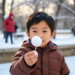a boy holding a snowball