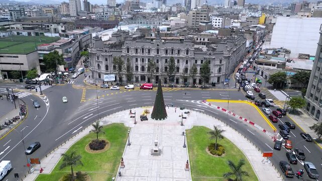 Drone capture of a vibrant urban square on a sunny summer day, showcasing the city&rsquo;s architecture and green spaces, Lima, Peru.