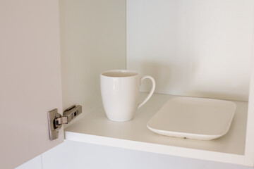 Minimalist Living Concept: Cup and Plate in Cabinet