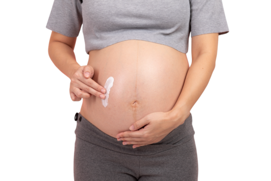 Pregnant woman applying cream to her belly for skincare and stretch mark prevention - Powered by Adobe