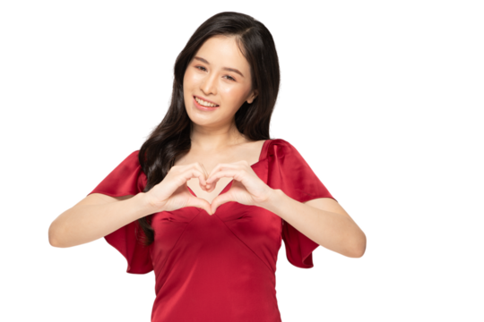 Smiling woman in red dress making heart gesture with her hands
