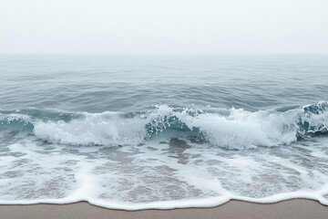 Obraz premium Ocean Wave Crashing on Sandy Shore in Fog
