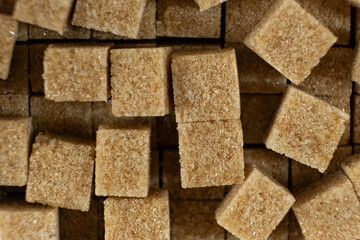 Cubes of brown cane unrefined demerara sugar.