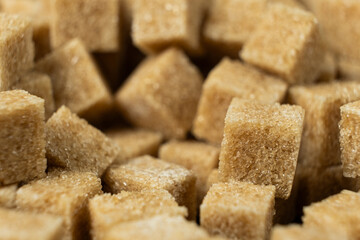 Macro cubes of brown cane unrefined demerara sugar.