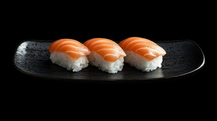 Close-up of glistening salmon sushi with rice and seaweed, displayed elegantly on a dark ceramic plate.
