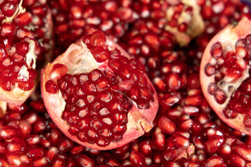 Pomegranate background, lots of peeled pomegranates and seeds