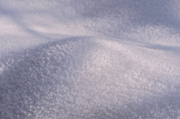 Obraz premium a snow hummock covered with crystallized snow with shadows