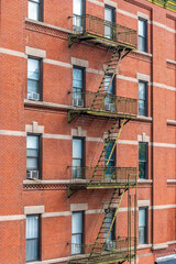 Obraz premium A view of fire exits on the side of a building viewed from the High LIne walkway in Manhattan,New York, in the fall