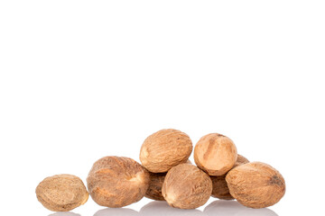 Several nutmegs, macro, isolated on white background.