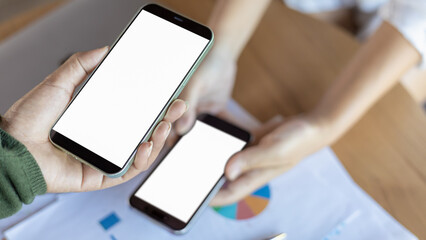 Payment or cashless technology concept, Hand using mobile phone application to scan, Hands holding mobile phone, Coffee shop accepting digital pay without money, Phone screen blank.