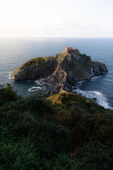 A church in the sea. Long winding steps leading to a church built on a cliff in the ocean. The sun...