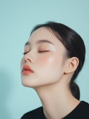 Fototapeta premium Serene Asian Woman with Single Eyelid in Creative Beauty Shot Against Gradient Blue and White Background