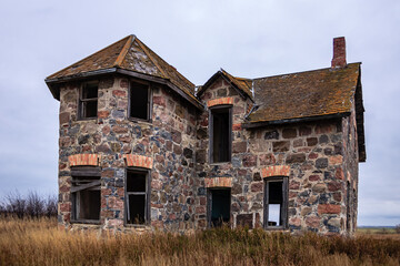 A large, old stone house with a slanted roof