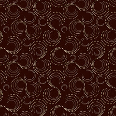 Seamless abstract dot pattern on dark brown background.