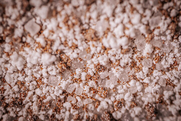 Macro shot of granulated instant coffee mix featuring sugar, milk powder, and coffee crystals. Detailed texture of the ingredients creates a vibrant composition.