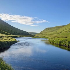 Serene river flowing through a verdant valley under a clear blue sky.