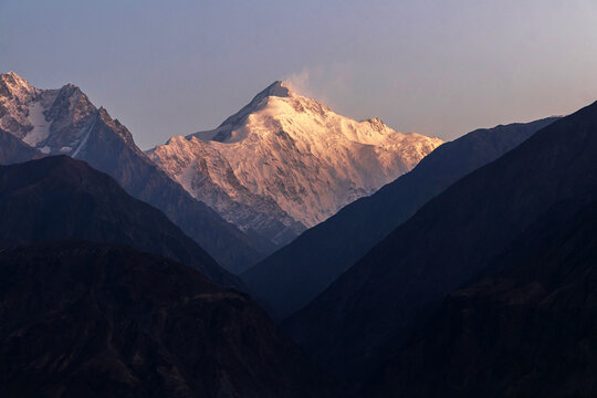 Majestic mountain peak bathed in sunrise glow. Rakaposhi is a mountain within the Karakoram range in Gilgit-Baltistan in Pakistan.